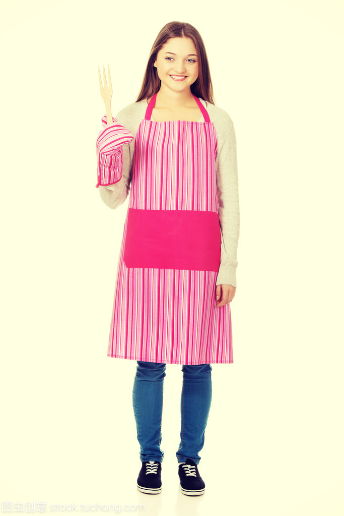 快樂的青少年女子穿廚房圍裙